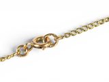 a close up of a gold chain on a white background