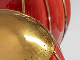 two red and gold vases sitting on a table