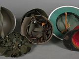 three helmets are lined up next to each other on a table