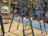 many ladders that are sitting in a room