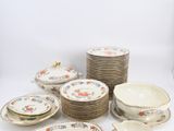 many plates and bowls that are sitting on a table