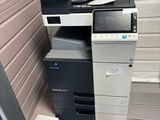 a printer sitting on top of a desk next to a monitor