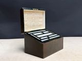 an old wooden box with four cards inside on a table