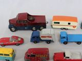 a lot of toy cars and trucks on a white surface