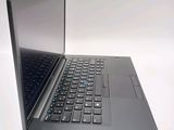 a laptop that is open on a white surface