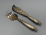 pair of silver plated serving utensils and a knife