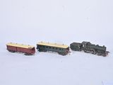 three toy trains sitting on a table in the snow