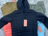 three jackets and pants laid out on the ground with a price tag on them