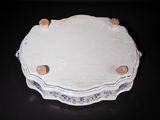 a white plate with a blue border on a black table