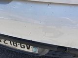 a close up of a car ' s front bumper with a number plate on it