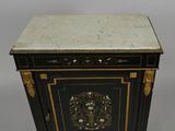 a black and gold cabinet with a marble top
