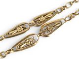 three long gold chains with ornate designs on them on a white surface
