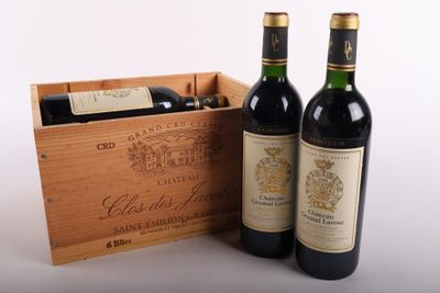 two bottles of wine in a wooden box on a white surface