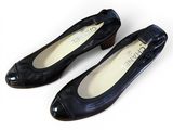 pair of women ' s black shoes on a white surface