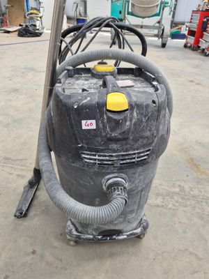a vacuum that is sitting on the floor in the garage