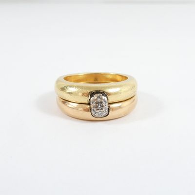a close up of a gold ring with a diamond in the middle