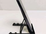 a cell phone on a stand on a white surface