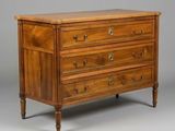 an antique chest of drawers with a wooden top