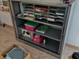a box that is sitting on the floor in front of a bookcase