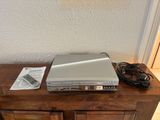 a silver laptop computer sitting on top of a wooden table