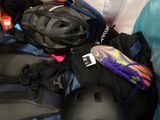 a pile of luggage with a helmet on top of it