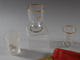three glasses and a box on a white surface