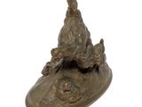 a bronze statue of a bird and a dog on a plate