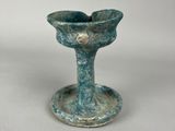 an image of a small blue vase sitting on top of a white table
