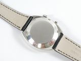 a close up of a watch on a white surface
