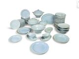 a pile of blue and white plates and bowls