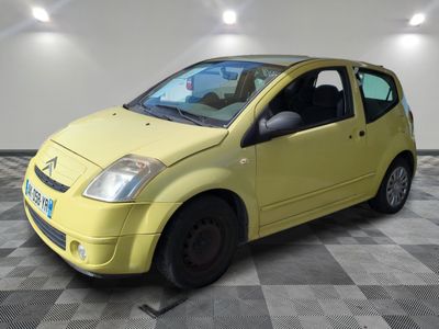 a picture of a small yellow car parked in a garage
