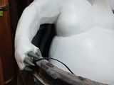 a white statue of a bear sitting in a barrel