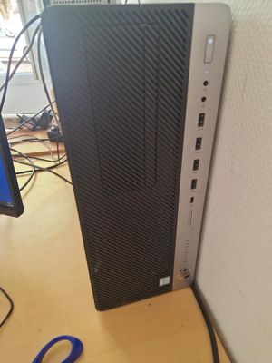 a desktop computer sitting on a desk next to a monitor