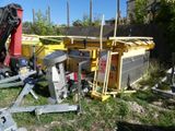 a pile of construction equipment that is sitting in the grass