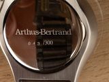 a close up of a watch on a wooden table