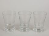 three shot glasses sitting next to each other on a table