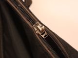 a black bag with a zipper on it sitting on a table
