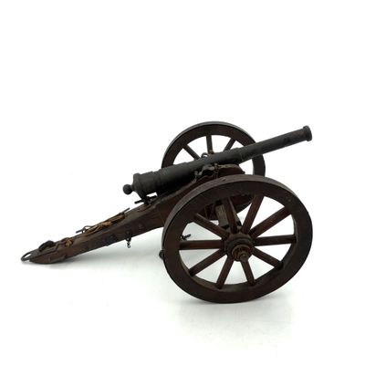 a toy cannon sitting on top of a wooden cart