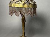 a lamp that is sitting on a table with beads on it
