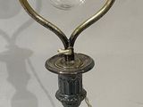 a lamp that is sitting on a table with a glass bulb