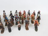 a lot of figurines that are on a white surface