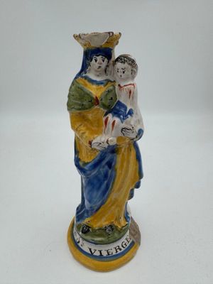 figurine d'une femme tenant un enfant dans ses bras