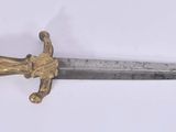 an image of a sword with a gold handle on a white background