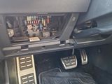 the interior of a car with a car floor mat and pedals in it