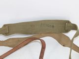 a belt with a metal buckle on it on a white surface