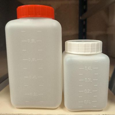 two plastic containers sitting on top of a shelf