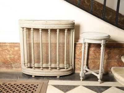 a small table with a stool next to it on a checkered floor