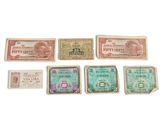 six different types of paper money sitting on top of a white surface