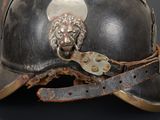 a helmet with a lion head on it on a black background