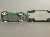two miniature cars that are sitting next to each other